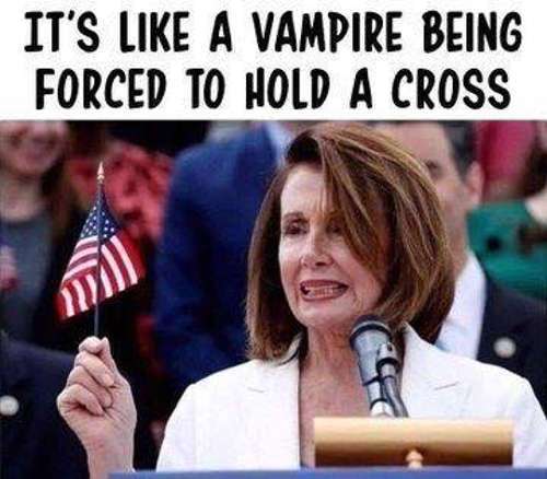 pelosi-its-like-a-vampire-being-forced-to-hold-cross-american-flag.jpg